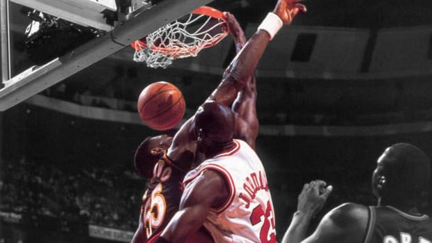 Michael Jordan dunking on Dikembe Mutombo