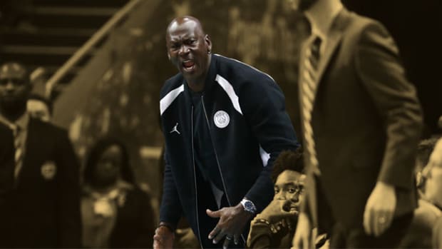 Charlotte Hornets team owner Michael Jordan yells from the bench