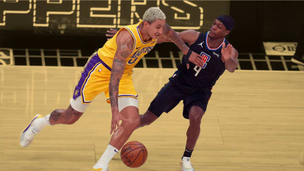 Los Angeles Lakers forward Kyle Kuzma is defended by LA Clippers guard Rajon Rondo