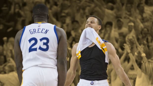 Golden State Warriors guard Stephen Curry celebrates with forward Draymond Green
