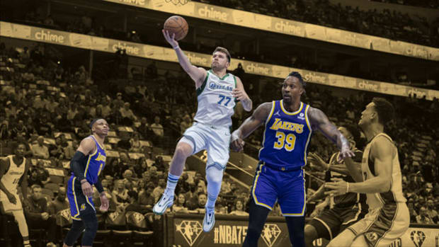 Dallas Mavericks guard Luka Doncic drives to the basket past Los Angeles Lakers center Dwight Howard and guard Russell Westbrook