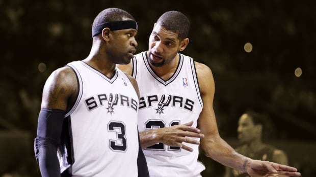 San Antonio Spurs forward Tim Duncan (right) and teammate Stephen Jackson (3) talk to each other