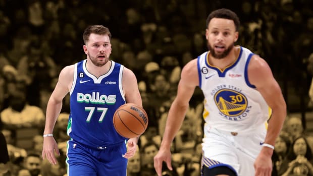 November 29, 2022; Dallas Mavericks' superstar Luka Doncic dribbles the ball as the Golden State Warriors' superstar Stephen Curry runs back on defense at American Airlines Arena.