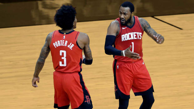 April 7, 2021; Houston Rockets guard Kevin Porter Jr. and John Wall celebrate after Wall's basket against the Dallas Mavericks at Toyota Center