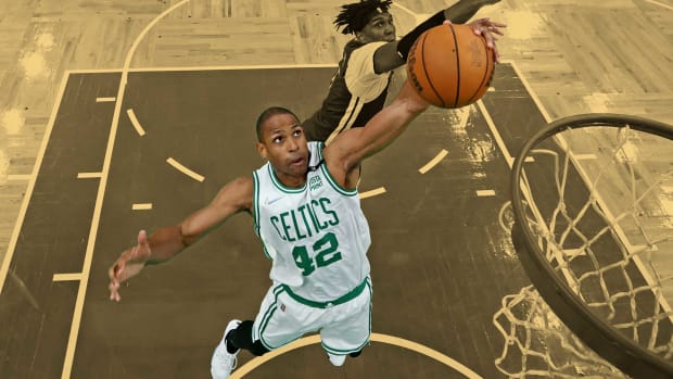 June 16, 2022; Boston Celtics big man Al Horford grabs a rebound against Golden State Warriors center Kevon Looney during Game 6 of the 2022 NBA Finals at TD Garden