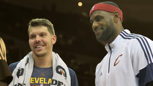 Cleveland Cavaliers forward LeBron James (right) reacts with forward Mike Miller (18)