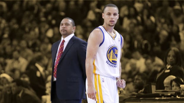 Golden State Warriors guard Stephen Curry looks on in front of head coach Mark Jackson