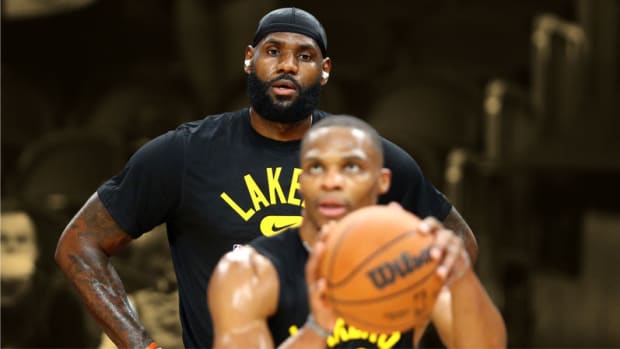 Los Angeles Lakers forward LeBron James watches guard Russell Westbrook shoot