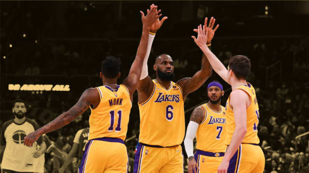 Los Angeles Lakers forward LeBron James celebrates with guard Malik Monk