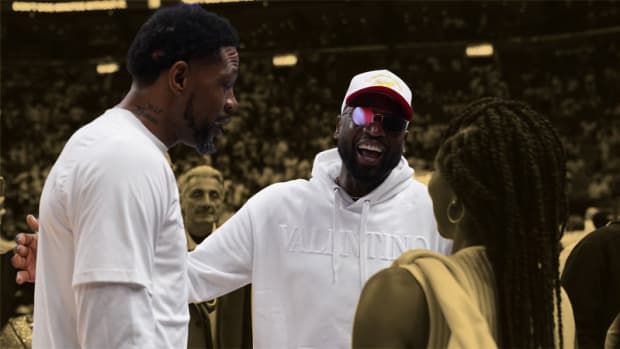 Miami Heat forward Udonis Haslem talks with former Miami Heat player Dwayne Wade