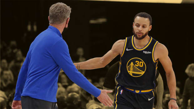 Golden State Warriors guard Stephen Curry celebrates with head coach Steve Kerr