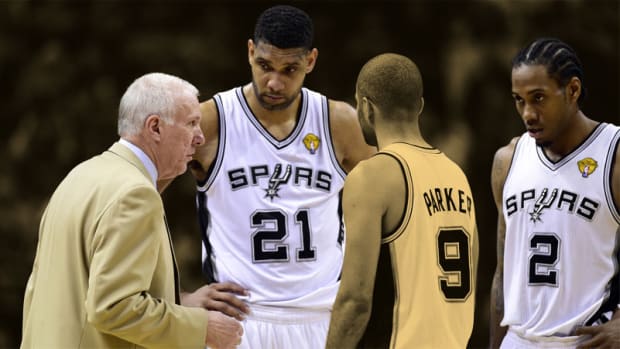San Antonio Spurs head coach Gregg Popovich talks to forward Tim Duncan guard Tony Parker and forward Kawhi Leonard