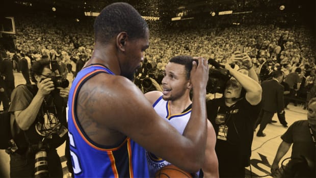 Golden State Warriors guard Stephen Curry is congratulated by Oklahoma City Thunder forward Kevin Durant