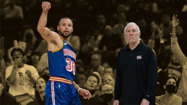 Golden State Warriors guard Stephen Curry and San Antonio Spurs head coach Gregg Popovich