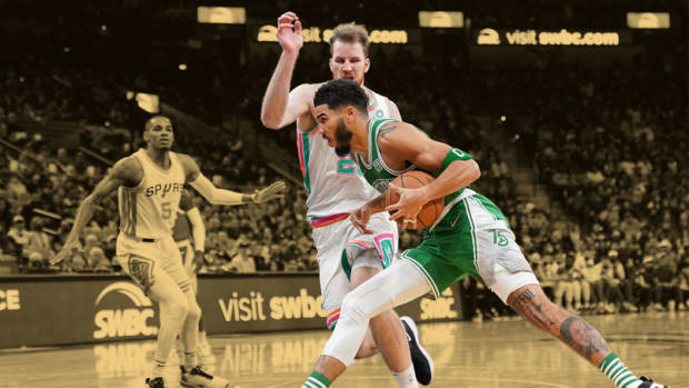 Boston Celtics forward Jayson Tatum drives in against San Antonio Spurs center Jakob Poeltl