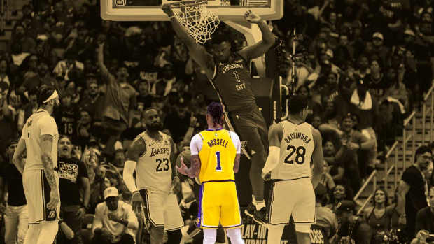 New Orleans Pelicans forward Zion Williamson (1) dunks the ball against Los Angeles Lakers forward LeBron James (23) and guard D'Angelo Russell (1) during the second half of a play-in game of the 2024 NBA playoffs at Smoothie King Center.