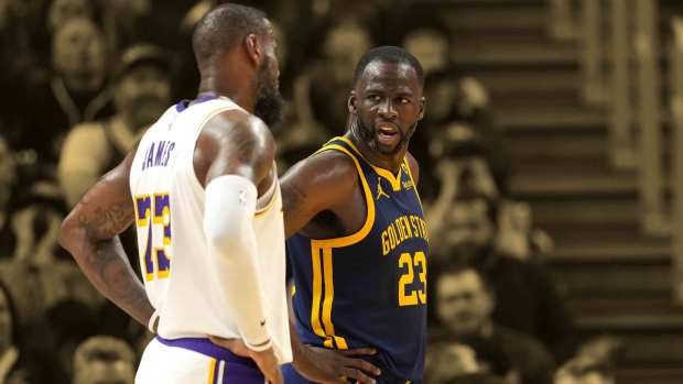 Golden State Warriors forward Draymond Green (right) talks with Los Angeles Lakers forward LeBron James