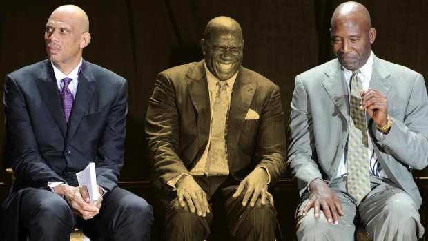 NBA players Kareem Abdul-Jabbar, Irvin "Magic" Johnson and James Worthy on stage during the ceremony unveiling the Kareem Abdul-Jabbar statue