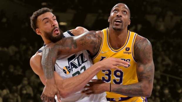 Los Angeles Lakers center Dwight Howard (39) tangles with Utah Jazz center Rudy Gobert (27) under the basket