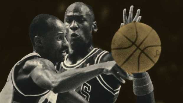 Sidney Moncrief dishes off as Chicago's Michael Jordan nears in 1988. 