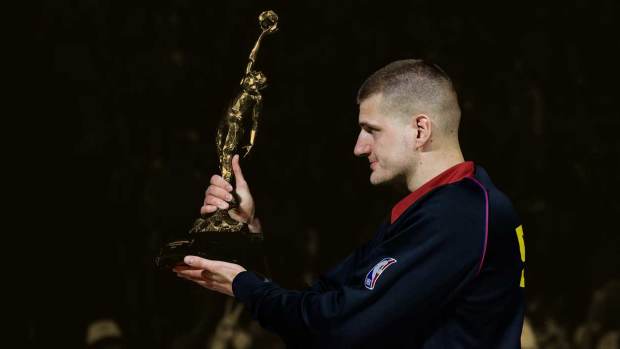 Denver Nuggets center Nikola Jokic (15) gestures with the KIA NBA MVP trophy to his teammates before game five against the Minnesota Timberwolves in the second round for the 2024 NBA playoffs at Ball Arena.