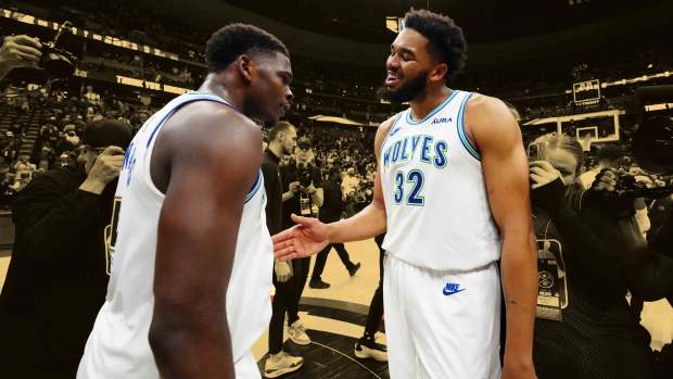 Minnesota Timberwolves guard Anthony Edwards (5) and center Karl-Anthony Towns (32) celebrate defeating the against the Denver Nuggets