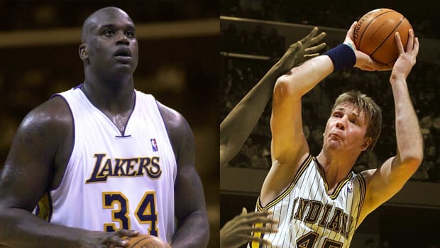 Los Angeles Lakers center Shaquille O'Neal at the free throw line; Indiana Pacers big man Rik Smits