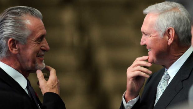 os Angeles Lakers former coach Pat Riley, left, and former Los Angeles Lakers player Jerry West talk before the start of the press conference held by the Magic Johnson foundation at the Staples Center.