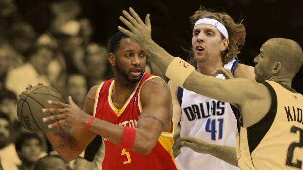 Houston Rockets guard Tracy McGrady (3) gets double teamed by Dallas Mavericks guard Jason Kidd (2) and Forward Dirk Nowitzki (41) in the first quarter at American Airlines Arena.
