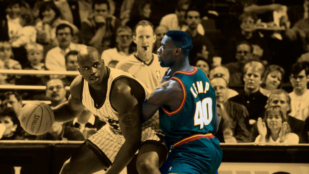 Orlando Magic center Shaquille O'Neal playing against Seattle Supersonics power forward Shawn Kemp in 1996.