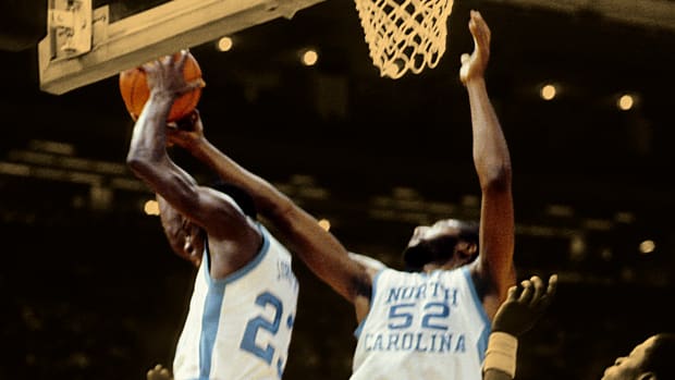 Mar 29, 1982; New Orleans, LA, USA; FILE PHOTO; North Carolina Tar Heels guard Michael Jordan (23) and forward James Worthy (52) in action against Georgetown Hoyas center Patrick Ewing