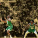 Golden State Warriors guard Stephen Curry goes to the basket past Boston Celtics guard Jaylen Brown, center Al Horford and guard Marcus Smart watching