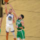 Golden State Warriors guard Stephen Curry shoots the ball against Boston Celtics center Al Horford and forward Jayson Tatum