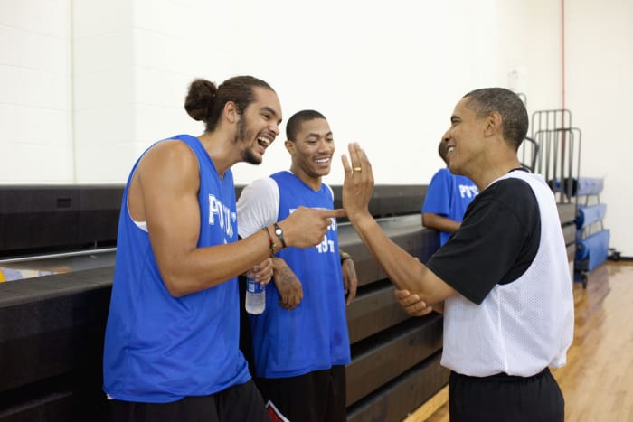 President Barack Obama jokes with Chicago Bulls players Joakim Noah and Derrick Rose. The President played basketball with friends, college and professional basketball players, before an audience that included wounded warriors and White House mentees at Fort McNair in Washington, D.C., August 8, 2010. (Official White House Photo by Pete Souza) This official White House photograph is being made available only for publication by news organizations and/or for personal use printing by the subject(s) of the photograph. The photograph may not be manipulated in any way and may not be used in commercial or political materials, advertisements, emails, products, promotions that in any way suggests approval or endorsement of the President, the First Family, or the White House.