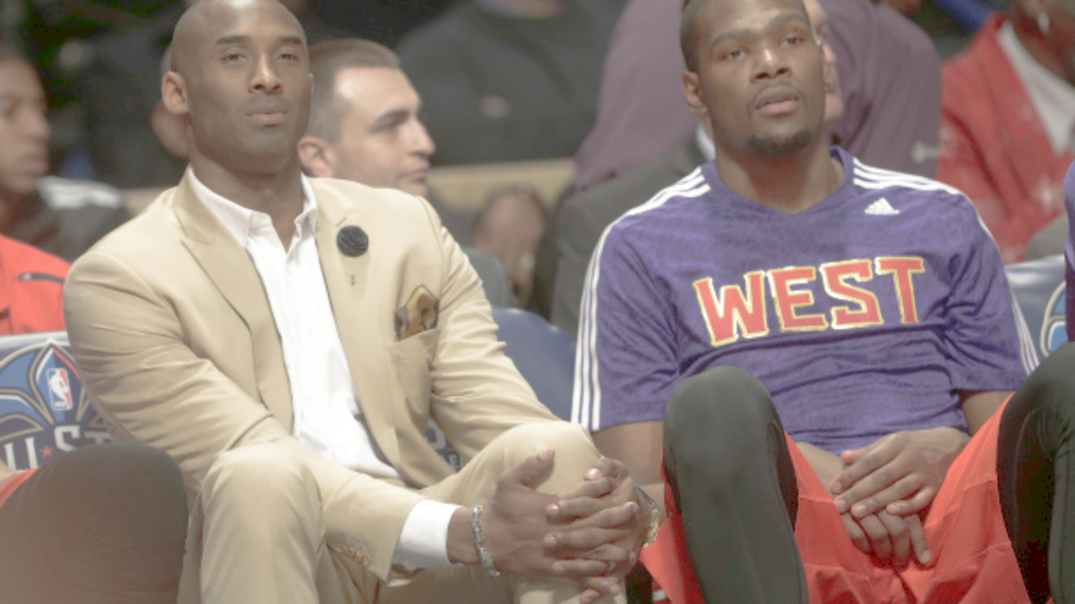 Los Angeles Lakers Kobe Bryant, left, sits with West Team's Kevin Durant, of the Oklahoma City Thunder during the NBA All Star basketball game, Sunday, Feb. 16, 2014, in New Orleans. (AP Photo/Gerald Herbert)