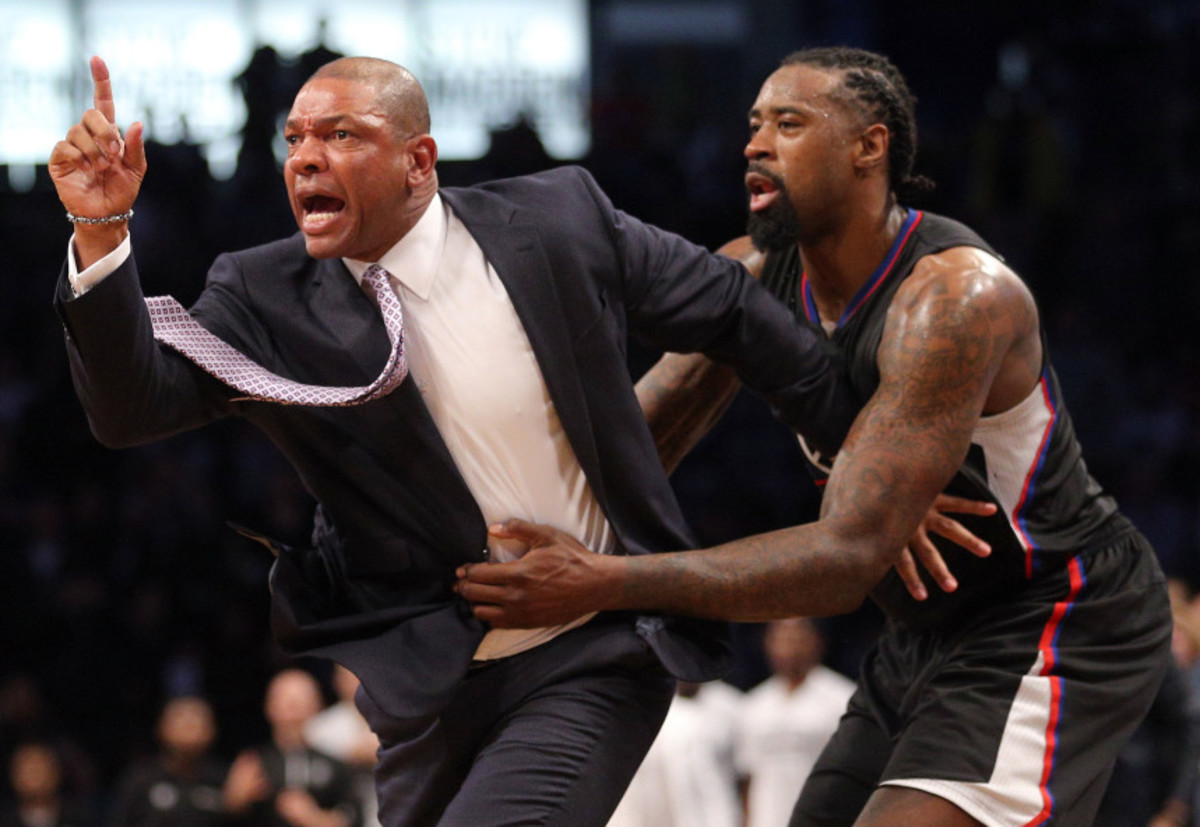 Nov 29, 2016; Brooklyn, NY, USA; Los Angeles Clippers head coach Doc Rivers is restrained by Los Angeles Clippers center DeAndre Jordan (6) as he argues with referee Ken Mauer (not pictured) after receiving a technical foul during the first overtime quarter against the Brooklyn Nets at Barclays Center. Rivers then received a second technical foul and was ejected from the game. Mandatory Credit: Brad Penner-USA TODAY Sports
