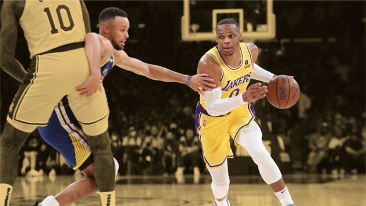 Los Angeles Lakers guard Russell Westbrook dribbles a ball against Golden State Warriors guard Stephen Curry