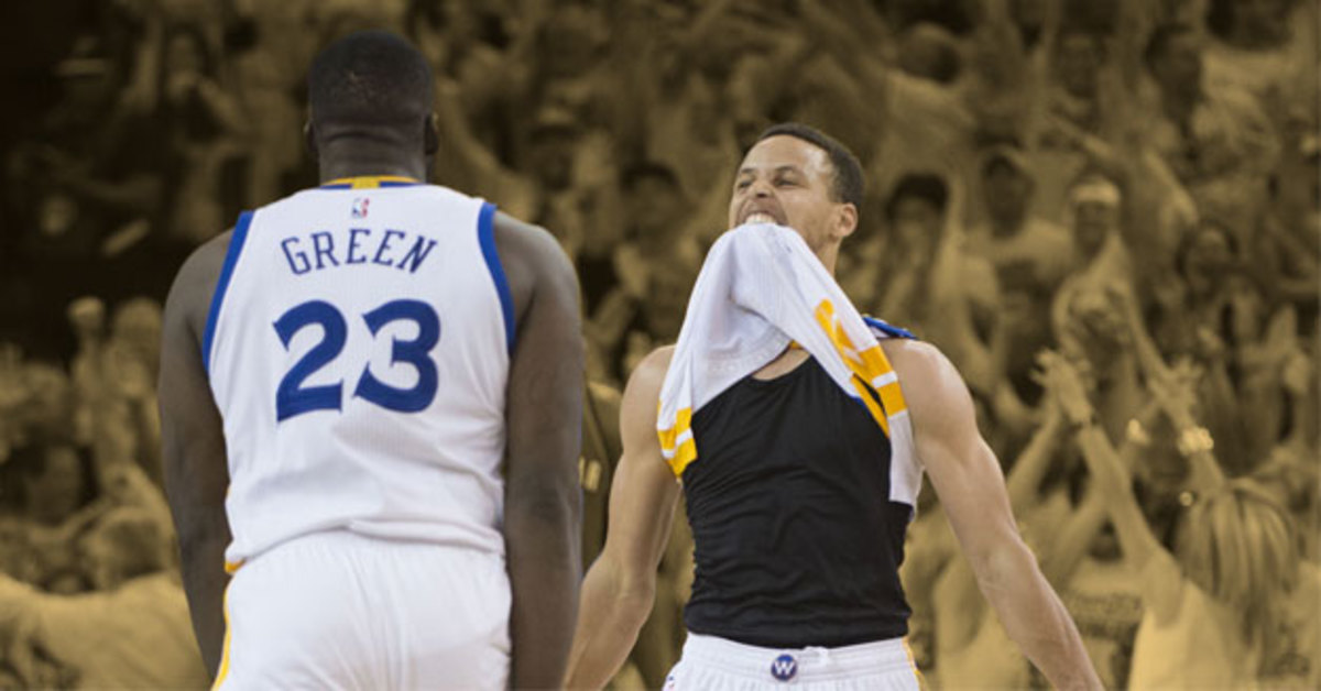 Golden State Warriors guard Stephen Curry celebrates with forward Draymond Green