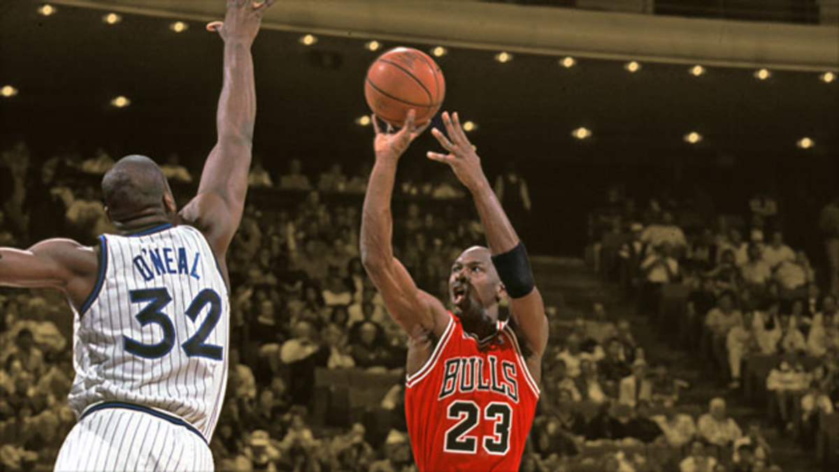 Chicago Bulls guard Michael Jordan shoots over Orlando Magic center Shaquille O' Neal