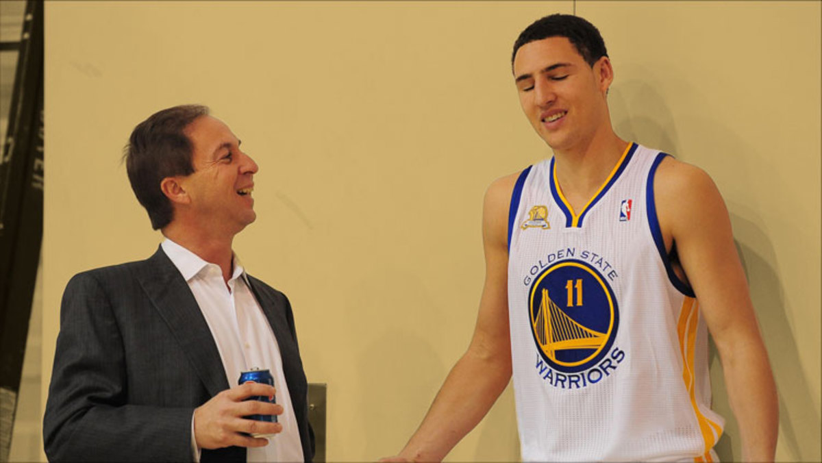 Golden State Warriors owner Joe Lacob talks with guard Klay Thompson