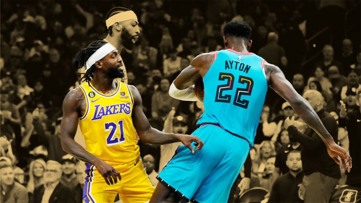 Los Angeles Lakers guard Patrick Beverley pushes Phoenix Suns center Deandre Ayton