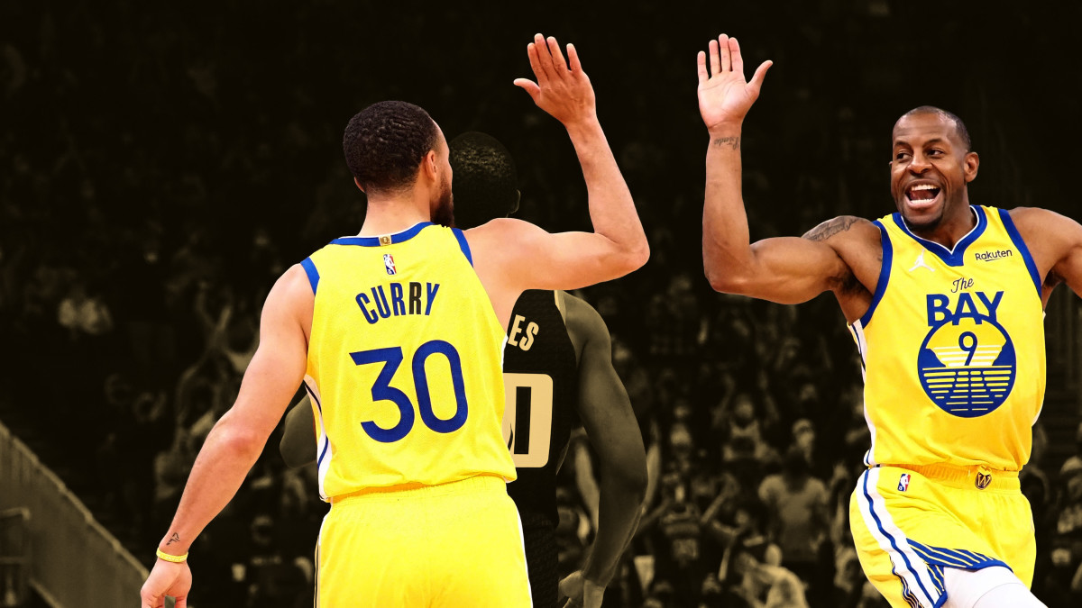 Golden State Warriors guard Stephen Curry high fives guard-forward Andre Iguodala