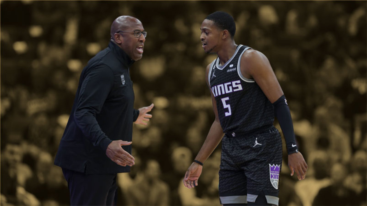 Sacramento Kings head coach Mike Brown gives instructions to guard De'Aaron Fox