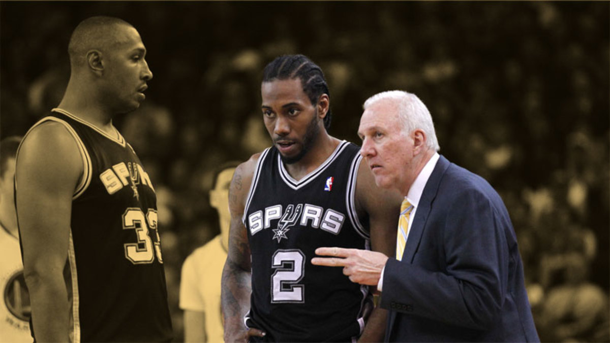 San Antonio Spurs head coach Gregg Popovich talks with forward Kawhi Leonard